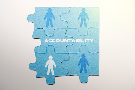 Piece of a jigsaw puzzle with Accountability text and a human figure symbol over a white background. Financial and business conceptの写真素材