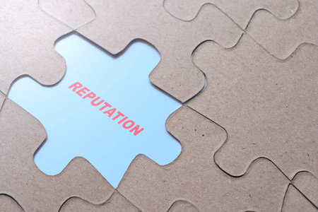 Piece of missing jigsaw puzzle with Reputation text over blue background. Business and finance conceptの写真素材