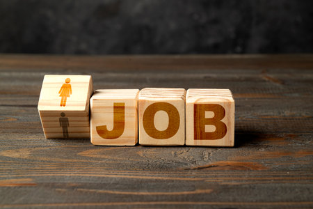 Wooden cubes with Job text. Wooden cubes turned and changed figures from woman to man. Human resources management conceptの写真素材