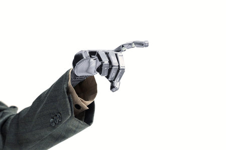 Robot hand in business suit reaching something isolated over white backgroundの写真素材