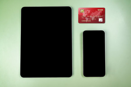 Credit cards and tablets with mobile phones with empty screens for mobile payment, banking, or...