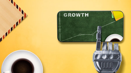 The robotic hand touches the mobile phone screen with a view of growth text with an increasing graph. Business growth conceptの写真素材