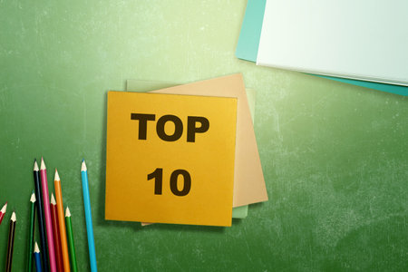 Stack of notes with the text of the top 10 over a colored background. Business conceptの写真素材