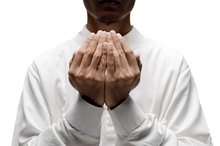 Muslim man raised her hands and prayed to Allah isolated over a white backgroundの写真素材