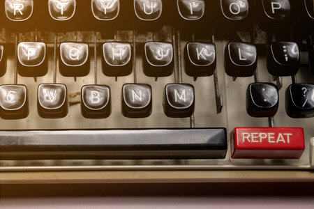 Text of repeat on a vintage typewriter button. New beginning of life, business or career conceptの写真素材