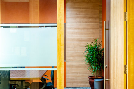 Door with window glass outside the meeting room in the workplace