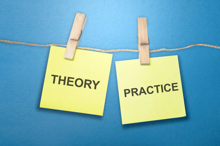 Paper hanging on the rope with 'Theory' and 'Practice' text. Tips and advice conceptの写真素材