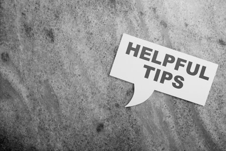 Bubble speech with 'Helpful tips' text on a black background. Tips and advice concept
