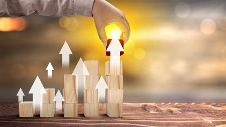 Business hand put stair stack of a wooden cube with increased graph arrow. Investment conceptの写真素材