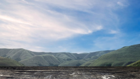 Wooden floor with mountain view with a blue sky background