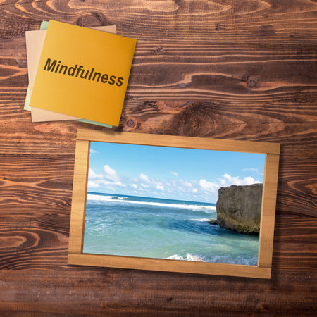 Stack of paper with mindfulness text and a small chalkboard with a nature view on the table. Health mindfulness conceptの写真素材