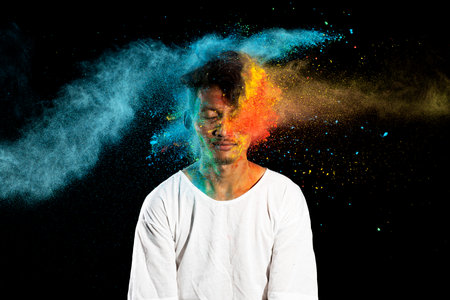 Portrait of a man celebrating Holi with colorful Holi powder. Holi festival concept
