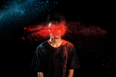 Portrait of a man celebrating Holi with colorful Holi powder. Holi festival concept
