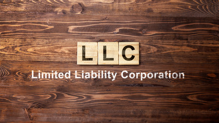A row of wooden cubes with LLC text, the acronym of Limited Liability Company. Business conceptの写真素材