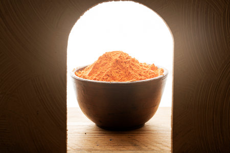 Close up of holi powder in wooden bowl on art decoration background with sunlight. Hindu spring festival concept.の写真素材