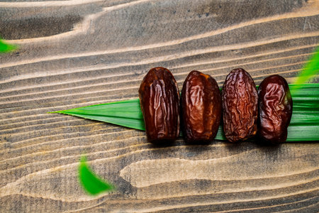Dried dates fruit for iftar on Ramadan on a wooden tableの写真素材