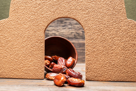 Image of tasty dried dates fruits in a bowl with mediteranian decoration. The Muslim feast of the holy month of Ramadan Kareem. Vegetarian and healthy snack.の写真素材