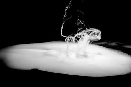 Swirly white smoke on a dark background. Abstract backgroundの写真素材