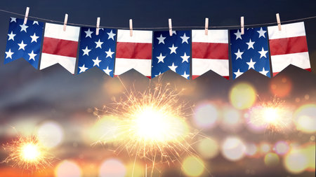 Closeup view of the American flag hanging on the rope with fireworks background. 4th of July concept