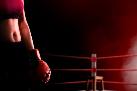 Portrait of a boxing woman with red boxing gloves in the boxing ringの写真素材
