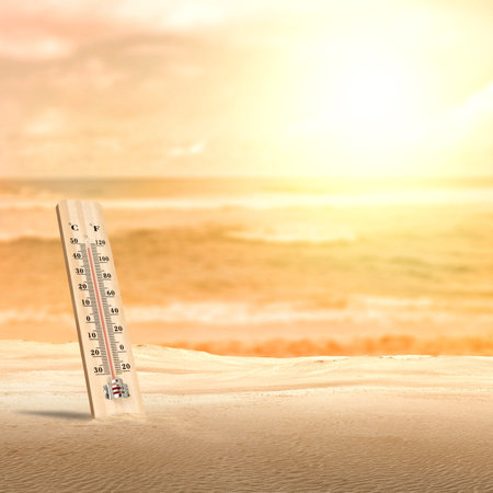 Thermometer with hot temperature in the desert. Environment, global warming, and climate change conceptの写真素材