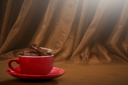 Chocolate pieces on chocolate drink in the cup on the table. World Chocolate Day conceptの写真素材