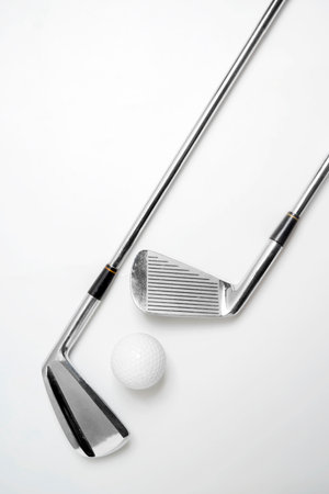 Closeup view of the golf club with the ball on a white background