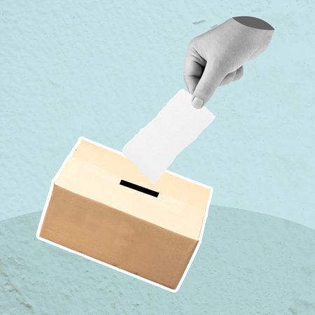 A person is putting a piece of paper into a box. The concept of voting and the importance of participating in the democratic processの写真素材