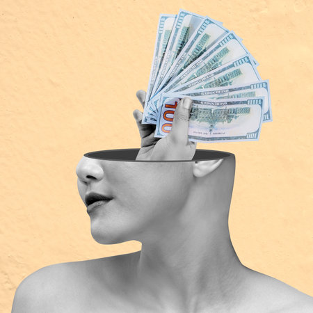 A woman's head is cut off and replaced with a pile of money. The image is meant to convey the idea of wealth and the importance of money in our livesの写真素材