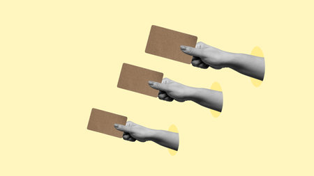 Three hands holding cards with a yellow background. The cards are pointing to something. The idea of the image is to show the importance of communication and the power of pointing to somethingの写真素材