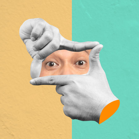 Human hand with hand camera gesture showing human eyes with a colored background. Collage art