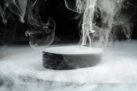 Black cosmetic container releases white smoke on a white surface. Beauty, care, and science blend in this captivating imageの写真素材