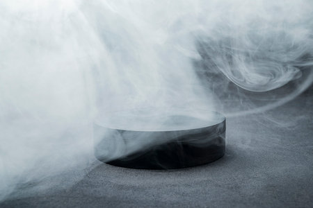 Empty podium or stage of cylinder shape for shows with smoke and dark backgroundの写真素材