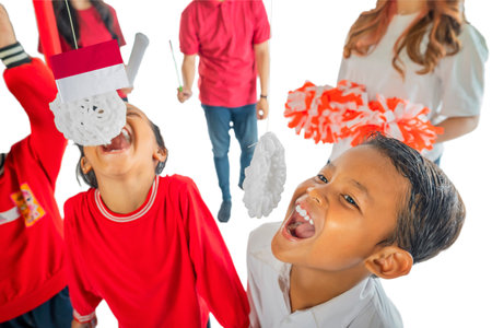 Portrait of Indonesian kids celebrate Indonesia Independence Day with traditional events like an eating crackers contest isolated over a white backgroundの写真素材