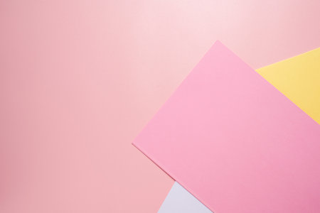 Pink, yellow and white paper with a pink background