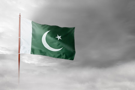 Pole with Pakistan flag waving in the air. Pakistan Independence Day conceptの写真素材