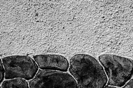 A close up of a stone wall with many small stonesの写真素材