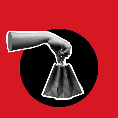 A hand holding a shopping bag with a black background. Concept of shopping and the concept of carrying items. Scene is casual and relaxed, as the hand is holding the bag with ease. Collage artの写真素材