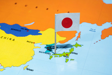 A map of Japan with a Japanese flag on it. The flag is red and white. Travel and government conceptの写真素材