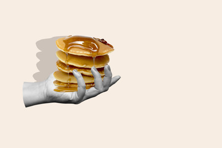 A hand holding a stack of pancakes with syrup dripping from them. Concept of indulgence and satisfaction, as the pancakes are a delicious. World Food Day. Collage artの写真素材
