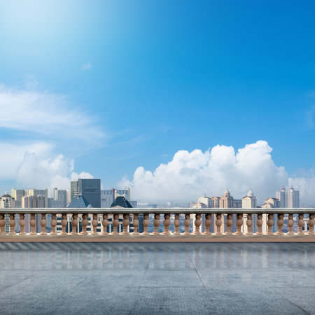 A city skyline with a clear blue sky and a few clouds. The city is bustling with activity and the sky is a beautiful backdropの写真素材