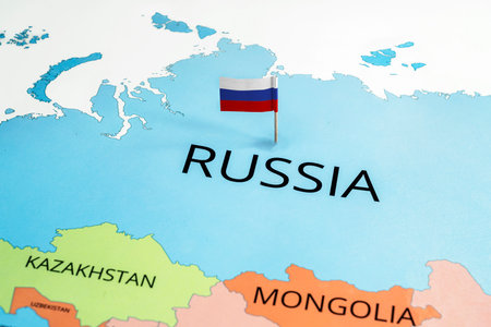 A map of Russia with the Russian flag on it. The flag colors are white, blue, and red. Travel and government conceptの写真素材