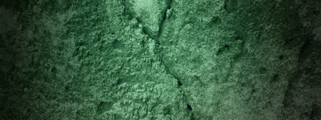 A dark background with a green stain on the grungy wall. Dramatic smoke or fog effect. Mockup. Copy Space. Wallpaper or Halloween backgroundの写真素材