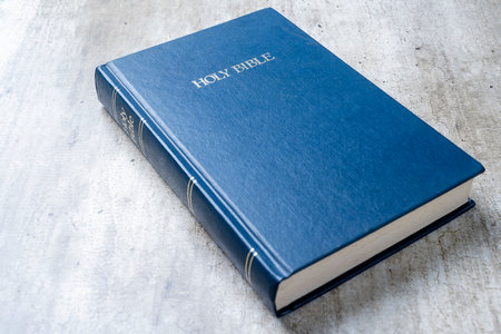 Blue book with the word Holy Bible on the front. Christian background, worship, church, symbols,...