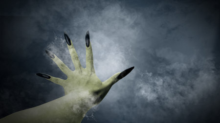 Witches hand with long nail claw is reaching out. The color is green. Evil, zombie, or monster hand is surrounded by smoke. The scene is scary and creepy. Spooky Halloween conceptの写真素材