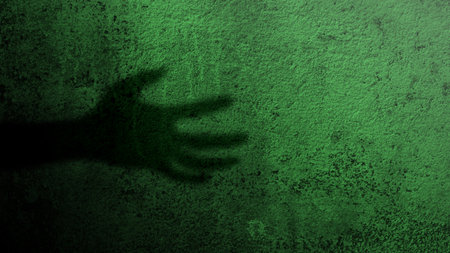 Shade of zombie hands on dark background. The hand appearing to be devil, evil, satan, or monster hands. Spooky Halloween conceptの写真素材