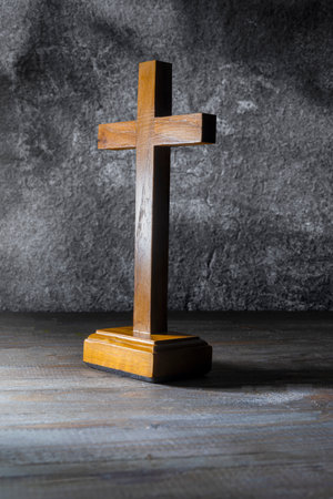 Wooden religion cross standing on black background. Religious christian holiday. Symbol of faith in God, Christianity Feast, Easter, Good Friday, Palm Sunday. Religious christian conceptの写真素材