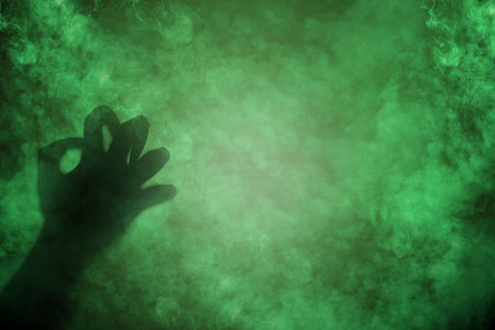 Shade of witch hands on dark background. The hand appearing to be devil, evil, satan, or monster hands. Spooky Halloween conceptの写真素材