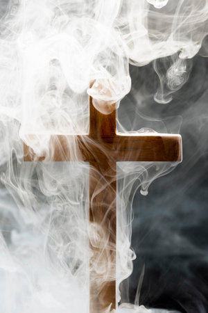 Religion christianity cross with smoke background. Symbol of faith and worship in God. Religious christian service, holiday or conceptの写真素材