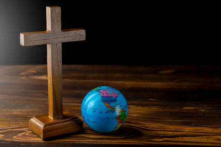 Religion christianity cross and globe on the table. Symbol of faith and worship in God. Religious christian service, missionary, holiday or conceptの写真素材